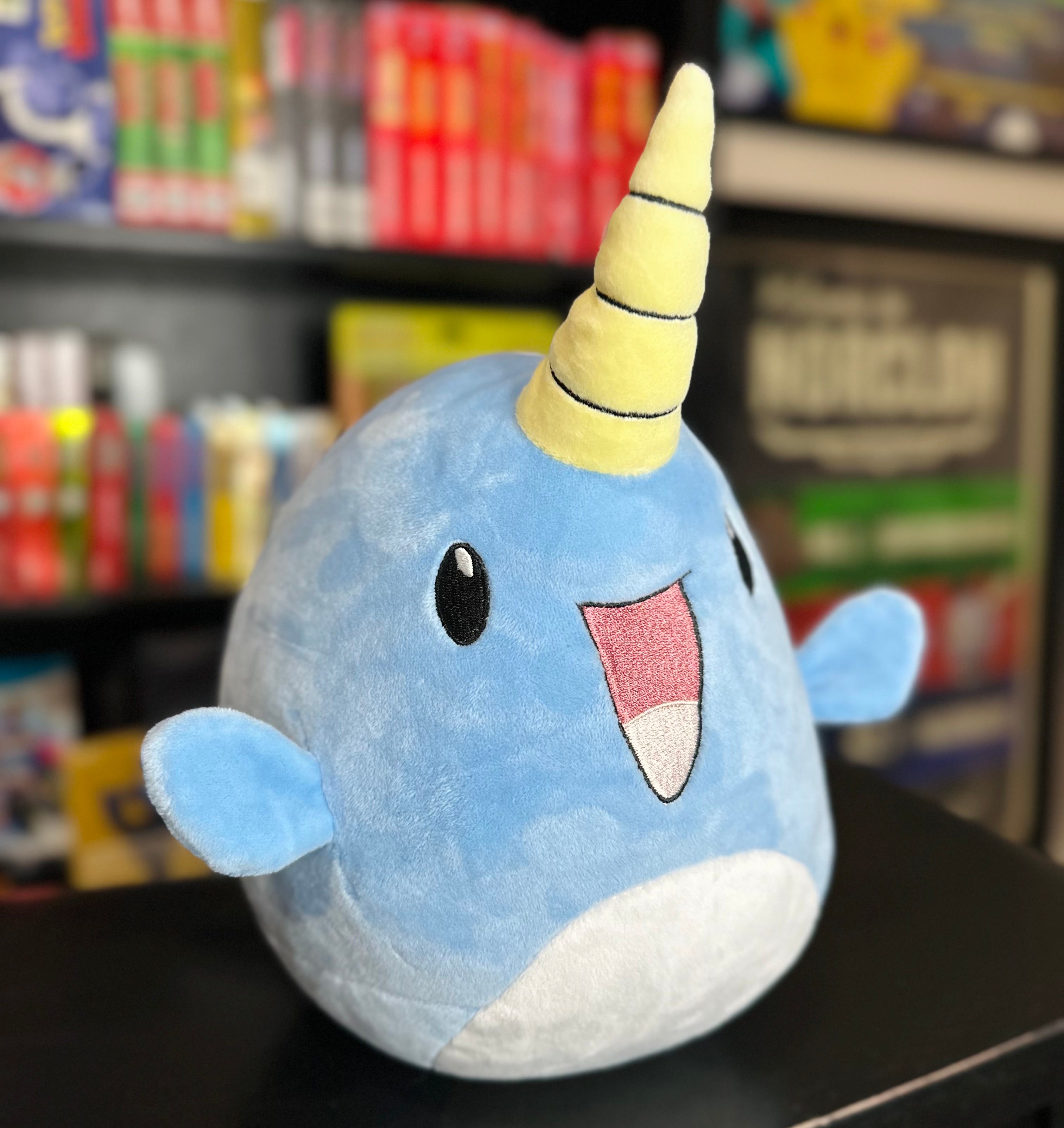 Side view of the Narwade plush from Histrobea Chronicles, a soft blue narwhal character with a yellow spiral horn and cheerful expression. Perfect for fans of HoopsandHipHop and collectible plush toys.