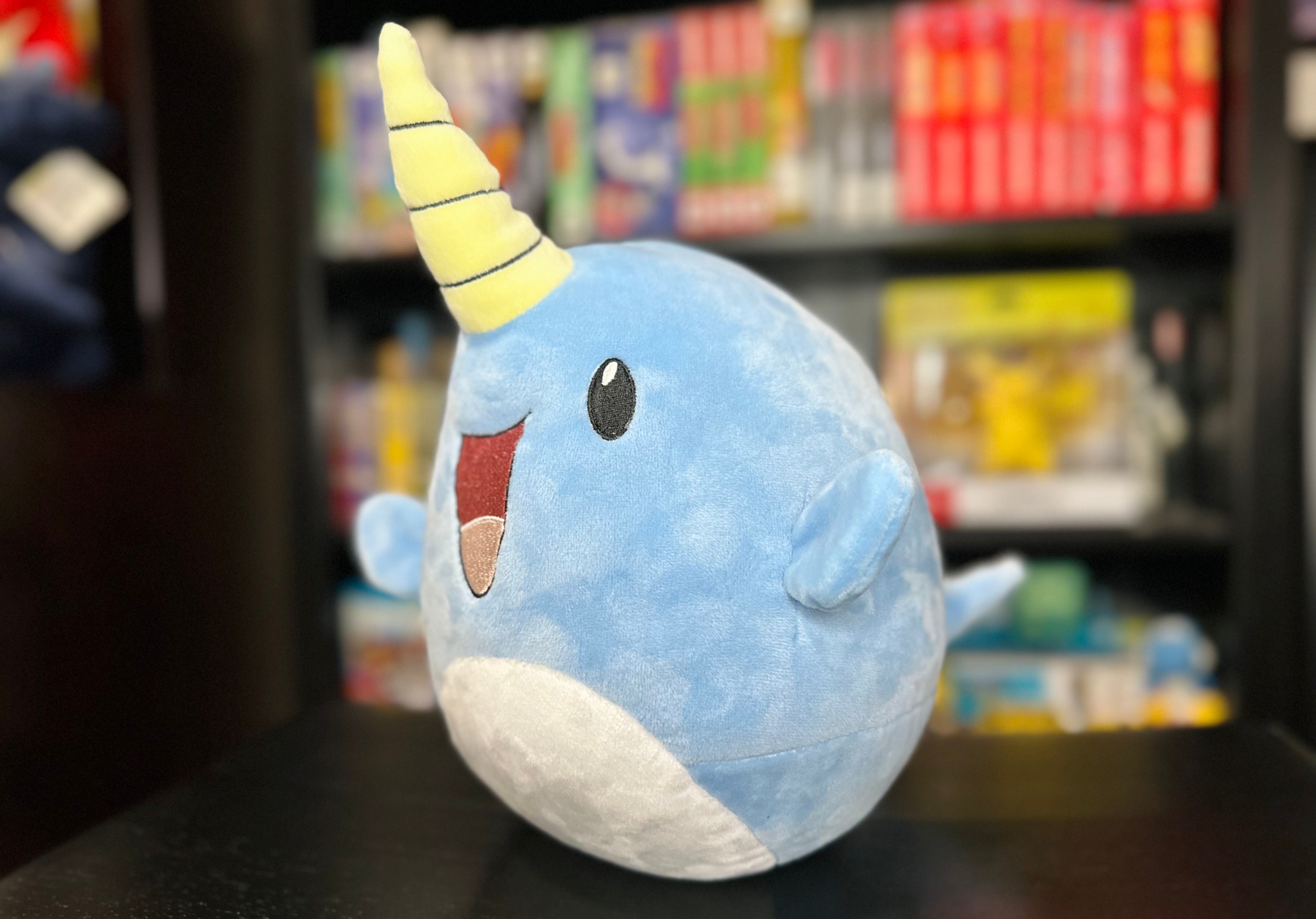 Three-quarter view of Narwade plush from Histrobea Chronicles, showcasing its playful design with blue fur, a cheerful smile, and a yellow spiral horn. A must-have for plush collectors.