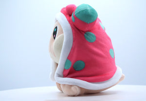 Side view of the Snugooi plush from Lockstin & Gnoggin's Lockemon series, showcasing its sea slug-inspired design with pink and blue hooded accents. A cute collectible plush for fans of the Lockemon universe.