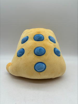 Back view of TOTYM's Jin Chan frog plush, showcasing blue circular spots on its soft beige body. Kawaii mythical creature plush designed for collectors.